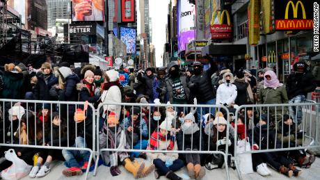 Spectators gather ahead of the New Year's Eve celebration in Times Square in New York, on Sunday, Dec. 31, 2017. New Yorkers, celebrity entertainers and tourists from around the world will pack into Times Square for what's expected to be a flashy but frigid celebration marking the start to the new year.
