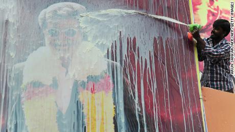 An Indian fan pours milk on a hoarding of Indian movie star, Rajinikanth, ahead of the release of his Tamil movie &#39;Kabali&#39; in Chennai on July 21, 2016.
