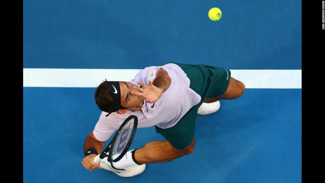 Roger Federer serves to Yuichi Sugita during a Hopman Cup match in Perth, Australia, on Saturday, December 30. Federer and the Swiss team defeated Sugita and the Japanese team 3-0.