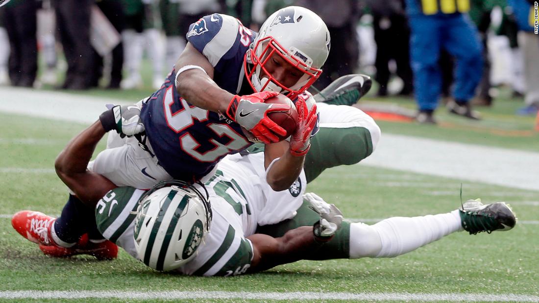New England running back Dion Lewis dives over New York Jets safety Marcus Maye to score a touchdown on Sunday, December 31. New England won 26-6 to clinch home-field advantage in the AFC playoffs.