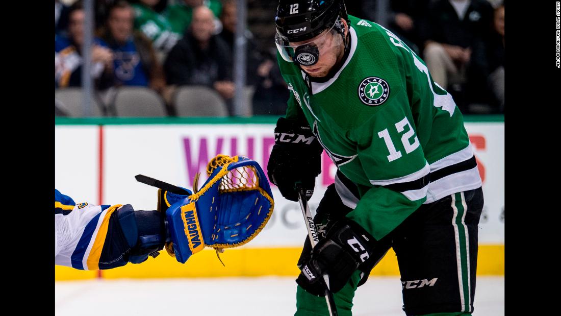 The puck bounces off the visor of Dallas center Radek Faksa during an NHL game on Friday, December 29.