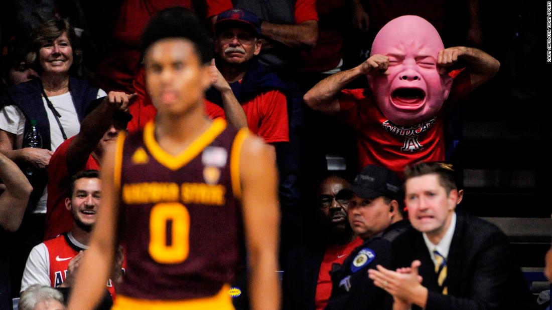 An Arizona basketball fan wears a baby mask during a college basketball game on Saturday, December 30.