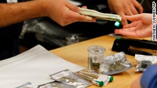 A customer buys marijuana at Harborside marijuana dispensary in Oakland.