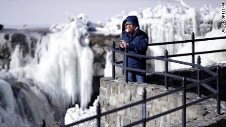 Obdulio Arenas looks over the partially frozen falls at the Paterson Great Falls National Historical Park in New Jersey on Tuesday. 