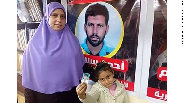 Ahmed Salama&#39;s wife and daughter are pictured in an undated image in Cairo. They are standing in front of a sign with Salama&#39;s image. Salama was  executed this week. 