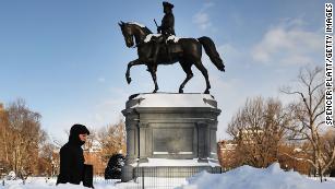 A pedestrian walks by a statue of George Washington in Boston&#39;s Public Garden on Friday, January 5, the morning after a massive storm. Blasts of arctic air have brought weather-related deaths, record low temperatures and historic amounts of snowfall to parts of the United States.