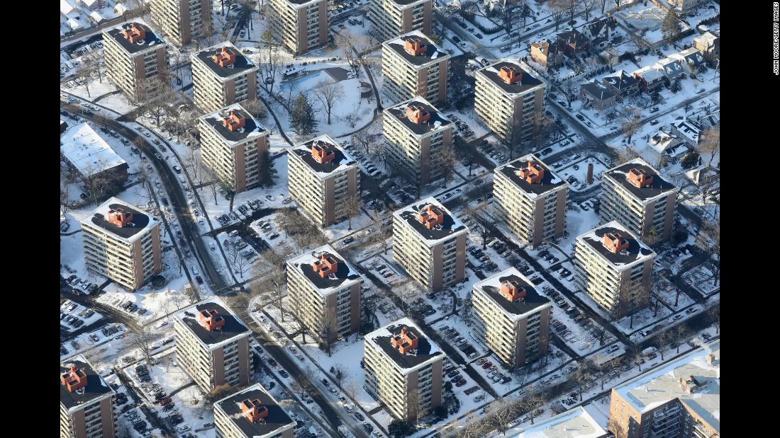 Apartment buildings in New York City poke out from the snow on January 5.