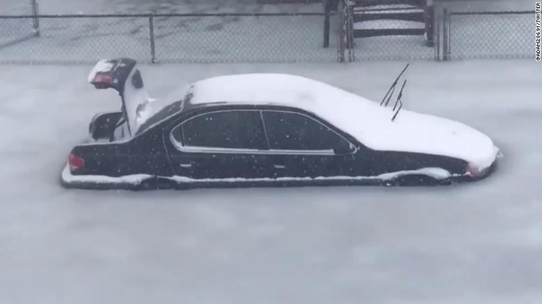 An abandoned car sits amid slush and ice in Revere, Massachusetts. 