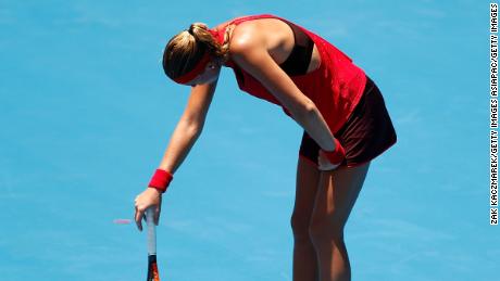 Kristina Mladenovic of France succumbs to the heat playing against Ellen Perez of Australia.