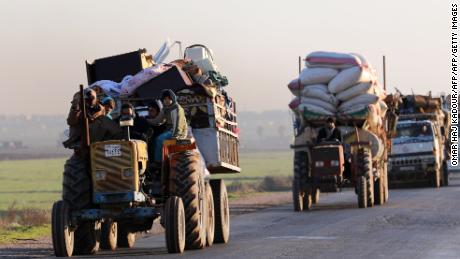 Syrians who fled Idlib province travel along a road in a rebel-held area near Saraqib on Sunday.  