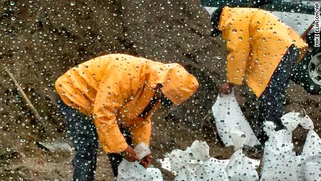 People fill up sandbags in preparation for the rains storms in parts of the fire-ravaged California&#39;s Santa Barbara County

