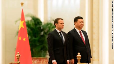 Chinese President Xi Jinping invites French President Emmanuel Macron to view an honour guard during a welcoming ceremony inside the Great Hall of the People on January 9, 2018.