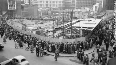 People queue to see the remains of the temple in 1954.