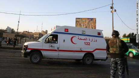 An Iraqi security officer stands guard at the site of the double suicide bombing on Monday. 