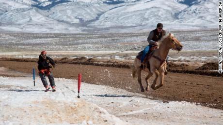 Horse, skier, and rider get to grips with the course in Saratoga, Wyoming.