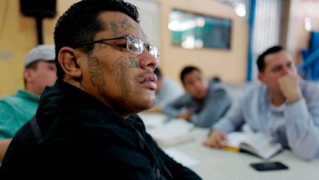 An ex-Barrio 18 gang member listens to a sermon at a church that welcomes former gang members into the congregation. 