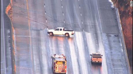 A pickup slides sideways on an icy patch Wednesday in Houston. The driver was able to regain control.