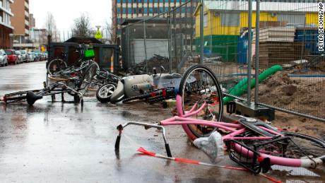 Bicycles and a scooter overturned by heavy winds lie in a street in Amsterdam, Netherlands, Thursday, Jan. 18, 2018.