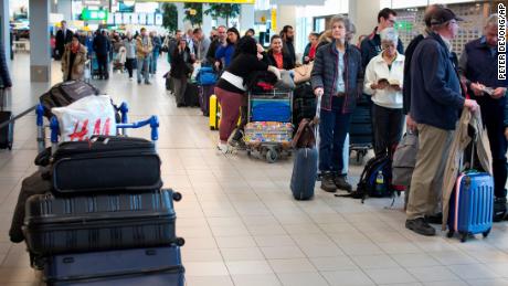 A group of travelers line up at Schiphol Airport near Amsterdam, Thursday.