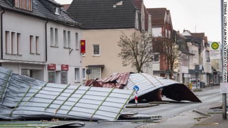 A picture taken on January 18, 2018 shows metal roofing sheets from a supermarket blocking a road in Menden, western Germany, as the region is hit by the storm named &quot;Friederike&quot;.
