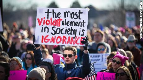 A demonstrator holds a sign at First Ward Park in Charlotte, North Carolina.