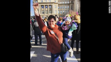Rachel Baxa and her 2-year-old daughter, Georgia, march in Boise, Idaho, on Sunday.