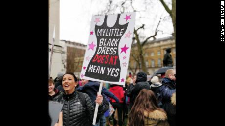A protester carries a sign while marching in London on Sunday.