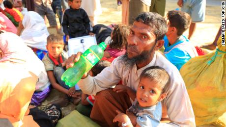 Mohammed Salim drinks water while sitting at the road side near Bhalukhali camp, Cox&#39;s Bazar. Even the final steps of his journey were an arduous process. At the border, he says a Bangladeshi money changer ran off with his money.  