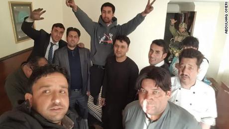 Abdulhaq Omeri (front left) and other survivors at the Intercontinental Hotel after security forces ended the siege.