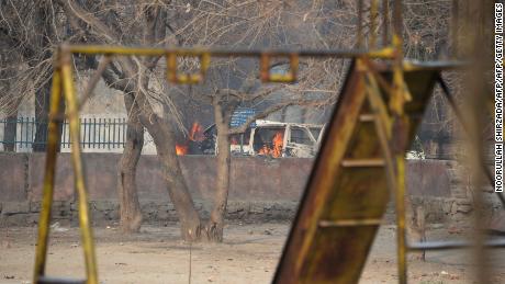 A vehicle burns near a playground next to an office of the charity Save the Children during an attack Wednesday in Jalalabad, Afghanistan.