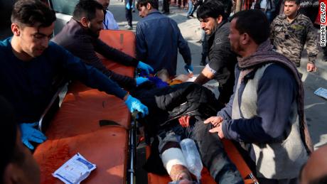 An injured man is moved to a stretcher outside a Kabul hospital following Saturday&#39;s attack.