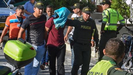 Police escort a suspect arrested in Saturday&#39;s blast in Barranquilla. 