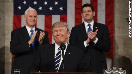 US Vice President Mike Pence (L) and Speaker of the House Paul Ryan (R) applaud as US President Donald J. Trump (C) arrives to deliver his first address to a joint session of Congress from the floor of the House of Representatives in Washington, DC, USA, 28 February 2017.  / AFP PHOTO / POOL / JIM LO SCALZO        (Photo credit should read JIM LO SCALZO/AFP/Getty Images)