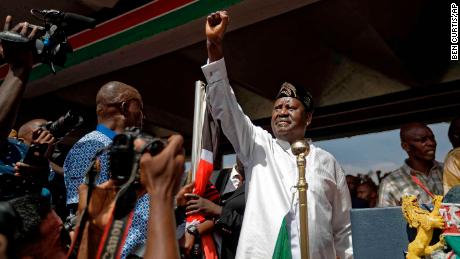 Opposition leader Raila Odinga holds a Bible aloft after swearing an oath during a mock inauguration ceremony at Uhuru Park in downtown Nairobi on Tuesday.