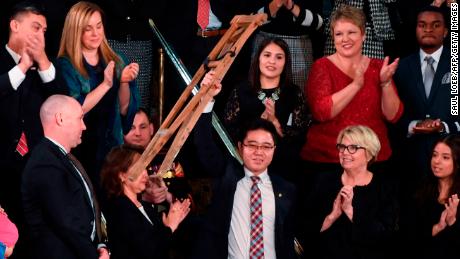 North Korean defector Ji Seong-ho raises his crutches as US President Donald Trump delivers the State of the Union address at the US Capitol in Washington, DC, on January 30, 2018.
 / AFP PHOTO / SAUL LOEB        (Photo credit should read SAUL LOEB/AFP/Getty Images)