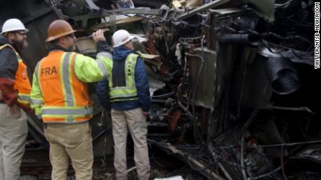 Investigators with the National Transportation Safety Board investigate Sunday&#39;s fatal collision.