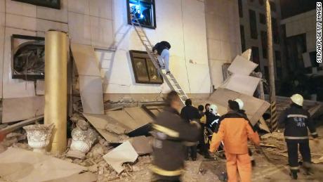 Rescue workers search through rubble outside the Marshal Hotel in Hualien early Wednesday.