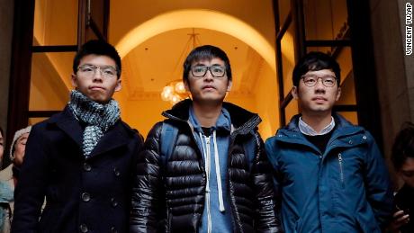 Pro-democracy activists Joshua Wong, Alex Chow and Nathan Law, walk out from the Court of Final Appeal in Hong Kong on February 6, 2018.