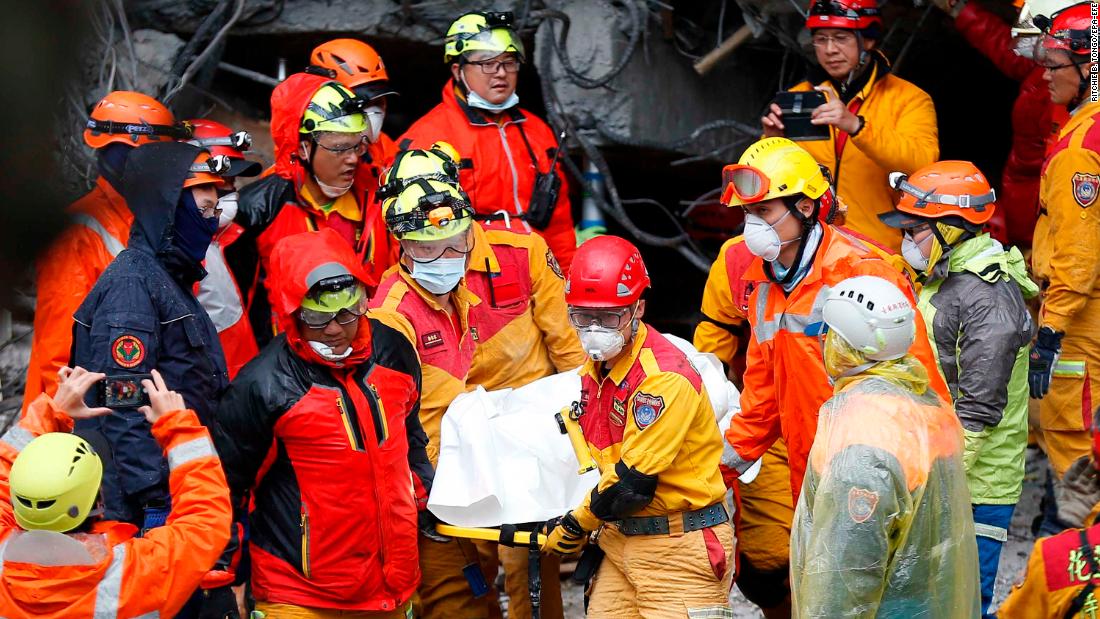 Emergency workers recover a victim from a destroyed building in Hualien on February 7.