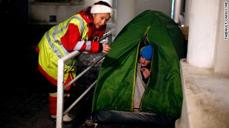 A volunteer worker talks with a homeless woman in Issy les Moulineaux, west of Paris, on Tuesday.