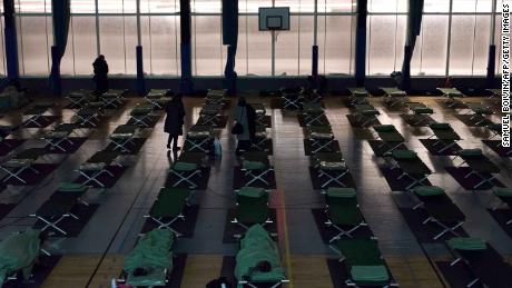 People stranded by the snow rest in an emergency shelter installed at the Robert Wagner gymnasium in Velizy-Villacoublay, southwestern suburbs of Paris.