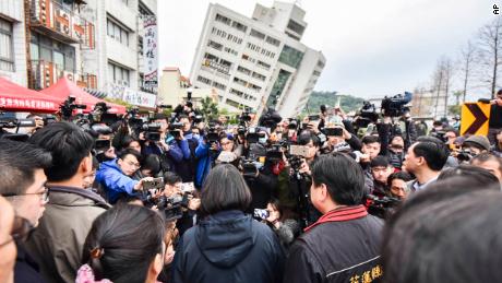 Taiwanese President Tsai Ing-wen, center, is briefed at the site of a collapsed building Wednesday.