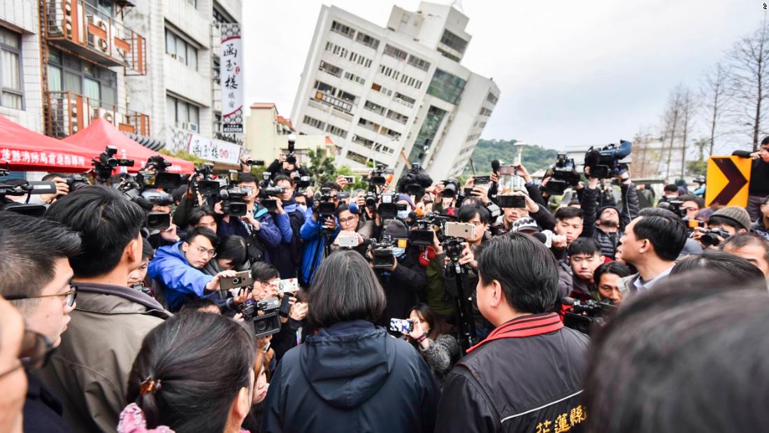 In this handout photo released by the Taiwan presidential office, President Tsai Ing-wen, center back-facing, is surrounded by media as she is briefed in Hualien on February 7.