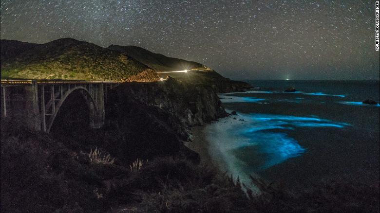 Phytoplankton concentrations in the waters below Bixby Creek Bridge illuminate the darkened waters. 