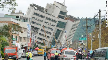 Emergency workers block off a street in Hualien, Taiwan, where a building threatens to collapse.