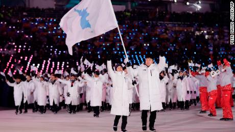 North Korea's Hwang Chung Gum and South Korea's Won Yun-jong arrive during the opening ceremony.