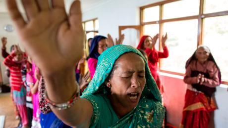 Nepalese Christians dance, sing and pray during a weekly church service in a small village of Tikhatal, in the Dolakha region of Nepal, 2017. 