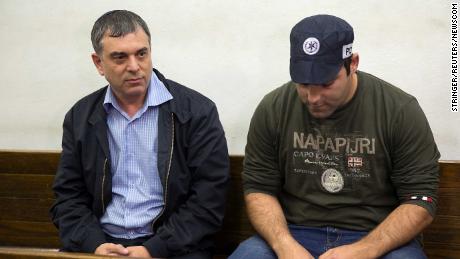 Shlomo Filber, left, sits at the Magistrate Court during his remand in Tel Aviv on February 18.
