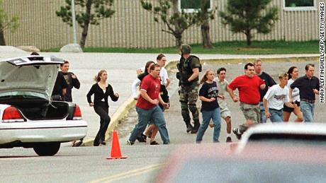 Columbine High School students are under police protection on April 20, 1999 in Littleton, Colorado.