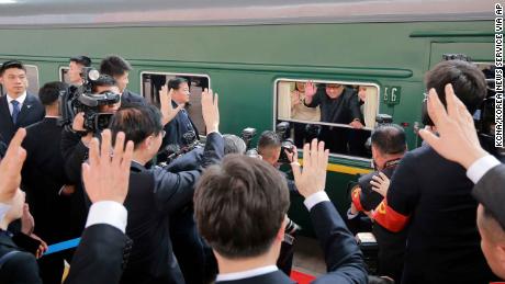 Kim Jong Un waves during his sendoff from Beijing station Tuesday.